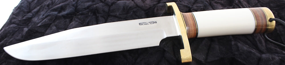 Randall Knife with a wooden handle on a dark textured background