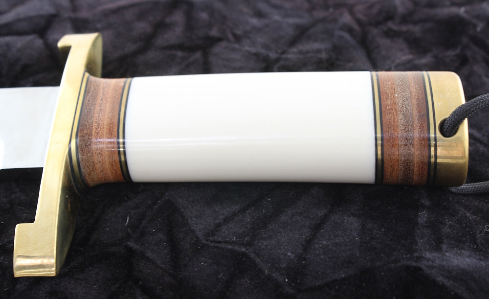 Sword sheath with gold and wooden accents on a black background