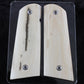Two wooden gun grips with metal screws on a clear background