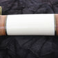 Sword sheath with gold and wooden accents on a black background